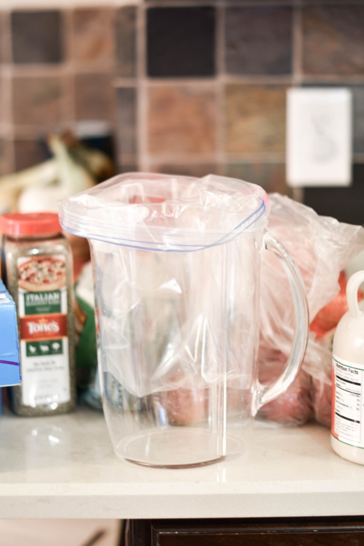 this is such a great hack for meal prepping - use a pitcher or bucket to hold your bag upright to fill with food. then, freeze that bag of food flat for easy storage and unthawing when it's time to pop your frozen meal into the slow cooker 
