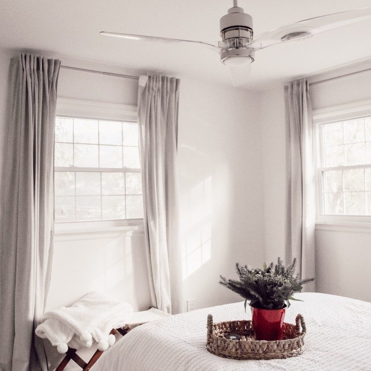 guest bedroom with white walls and white bedding