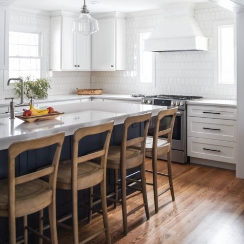 white kitchen with navy island cover