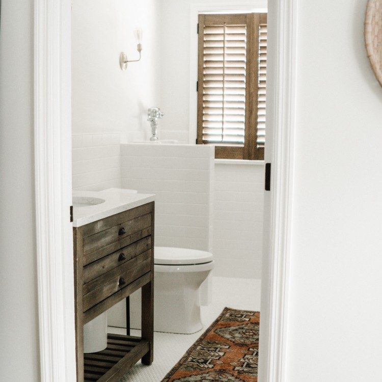 white half bathroom with a urinal