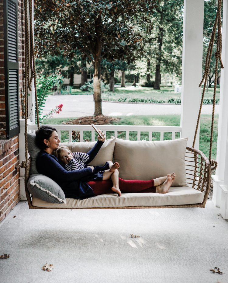 outdoor woven swing on front porch