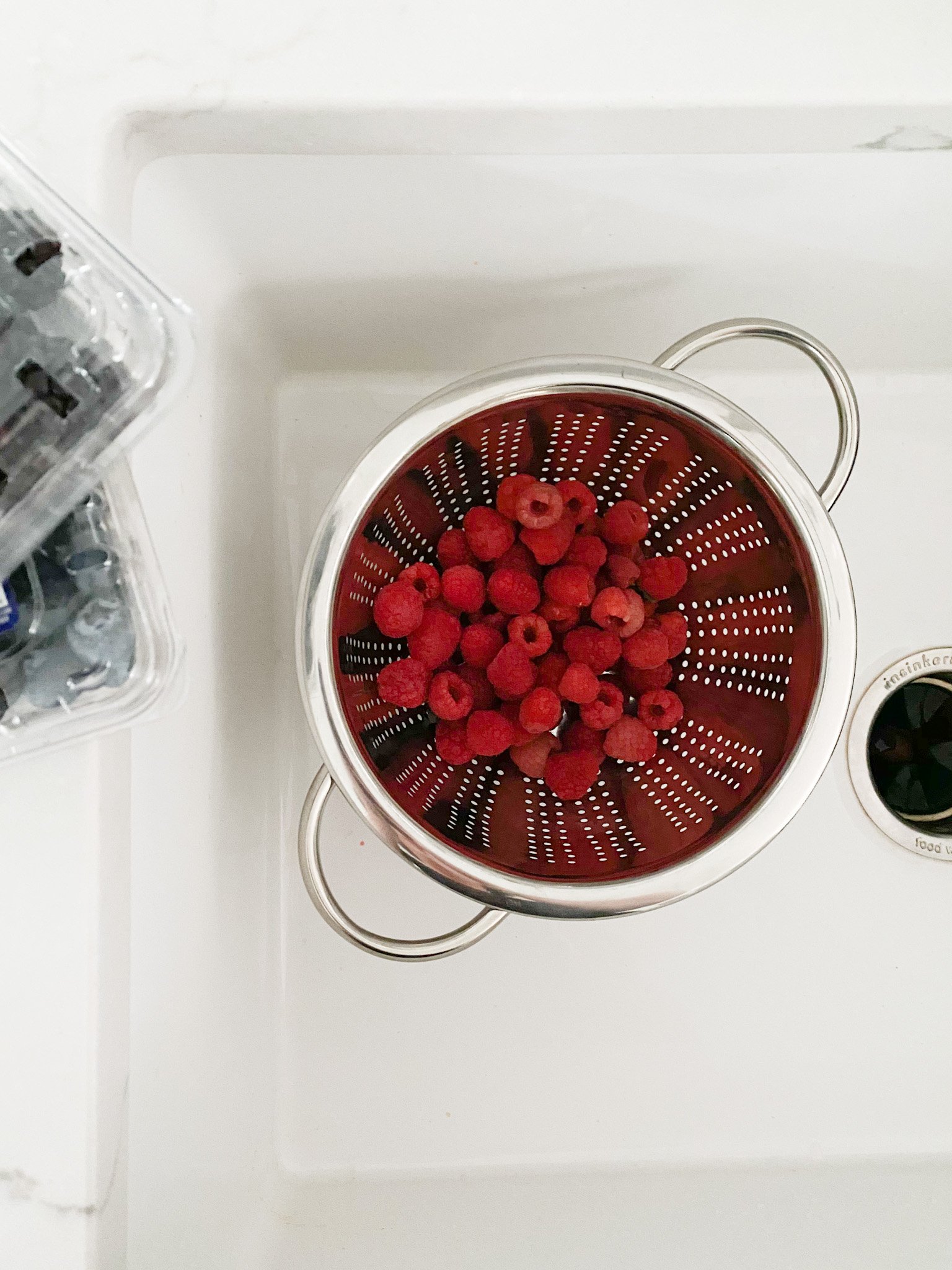 raspberries in a colander 