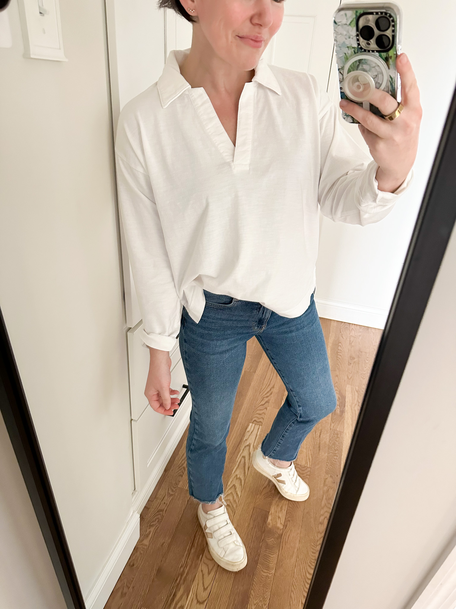 Women's Fashion Outfit, Faherty Sunwashed Long-Sleeve Polo in White, Blue Jeans with cut-off ankle, White and Gold Veja Sneakers
